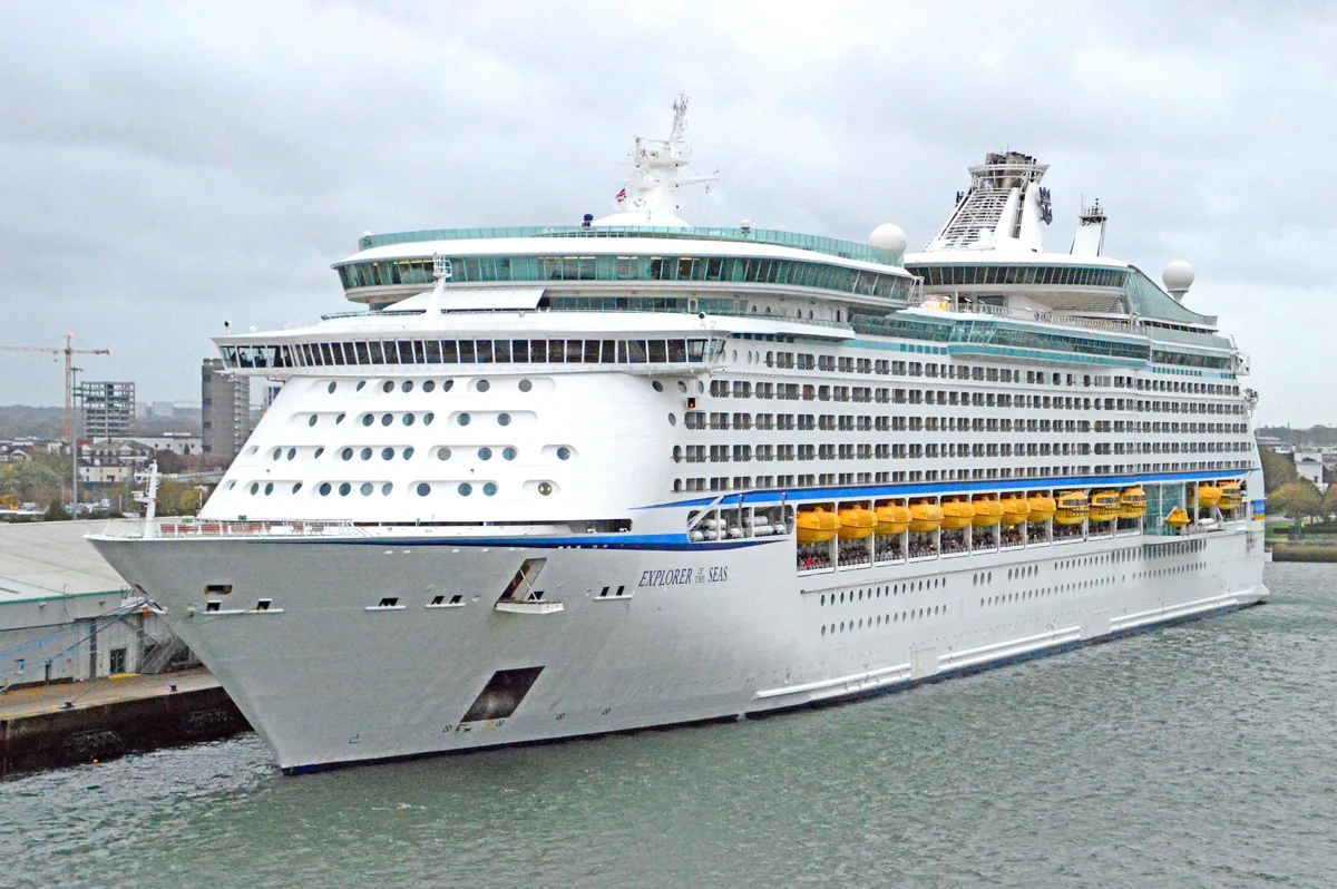 The cruise ship Explorer of the Seas is moored in the port of Southampton beneath a hazy sky.